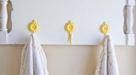 Turn an old headboard into a towel holder or coat hanger. Such a fun DIY project!