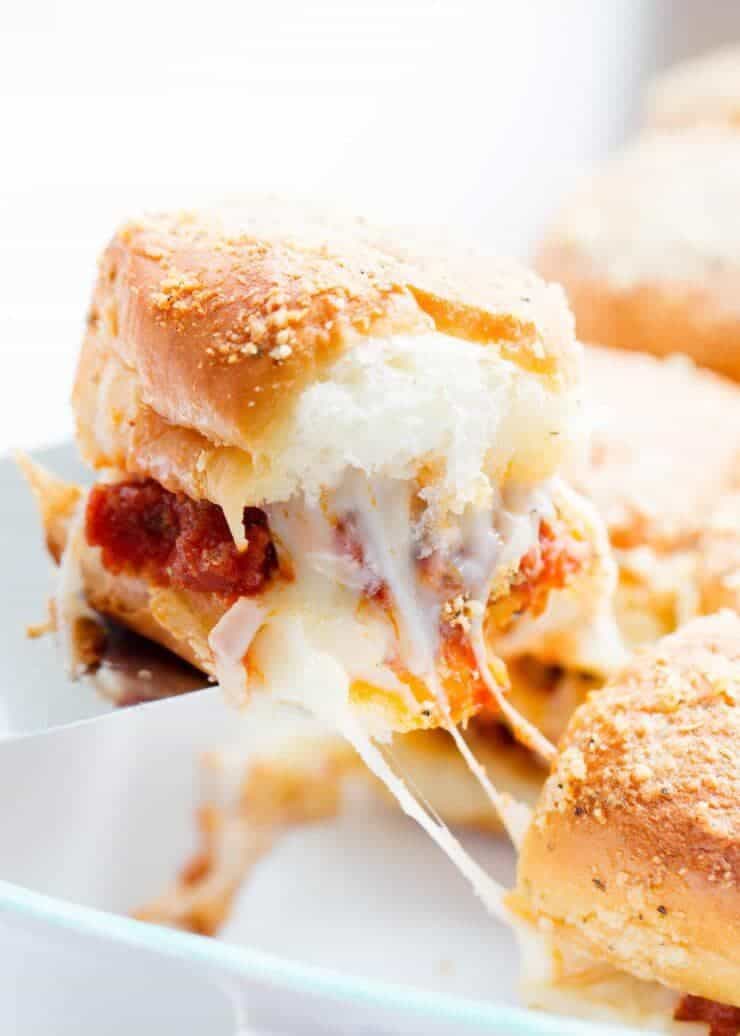 These delicious meatball sliders are the perfect EASY appetizer to make for your next party! They're made with Hawaiian rolls, meatballs, marinara, mozzarella and topped with a delicious butter and parmesan seasoning. 