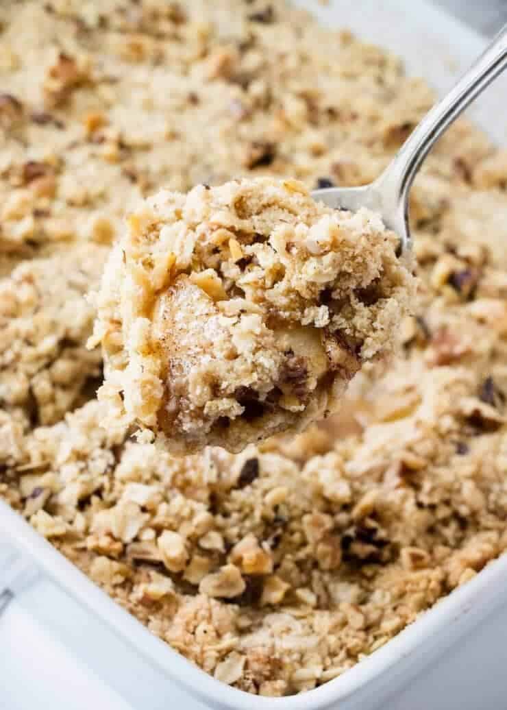 scooping apple crisp out of the pan