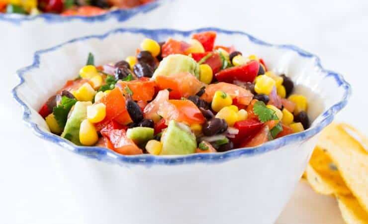 Delicious black bean salsa filled with corn, tomatoes, peppers, avocados, lime juice and fresh cilantro. An appetizer everyone loves!