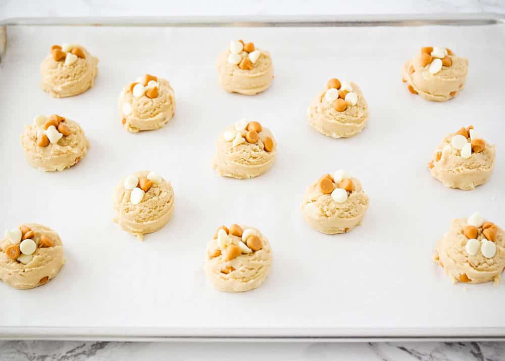 Butterscotch cookie dough balls on a baking sheet. 