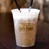 butter beer in a harry potter plastic cup with 2 straws