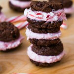 a stack of chocolate cookies filled with candy cane buttercream