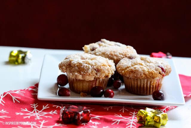 crumb topped cranberry eggnog muffins on white plate 