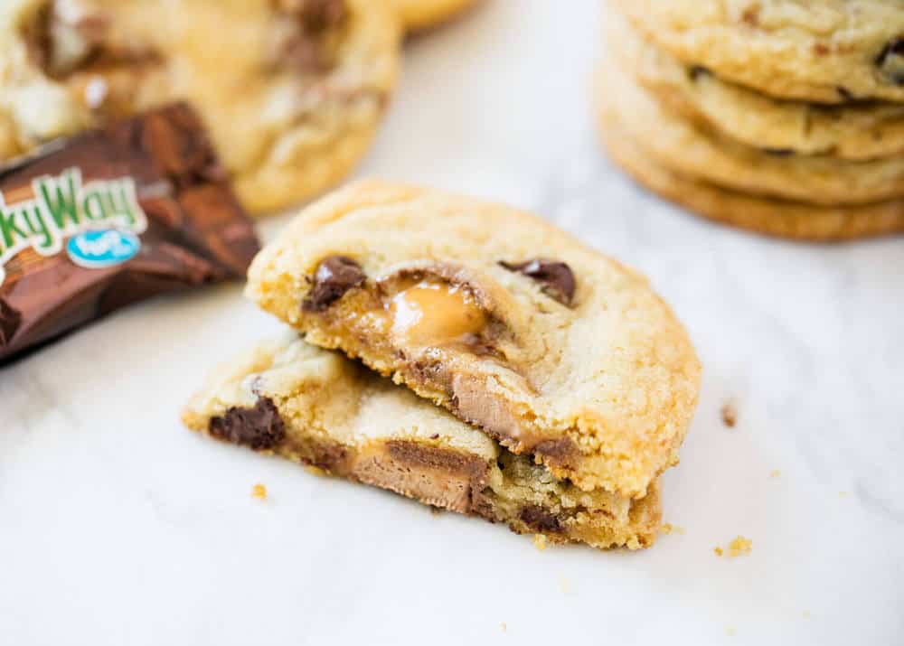 Super soft chocolate and caramel milky way cookies that literally melt in your mouth. A chocolate caramel lovers dream. Milky way cookies stacked on top of each other.