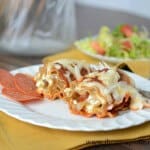 pepperoni pizza lasagna roll ups on white plate
