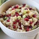 quinoa pomegranate salad in a white bowl