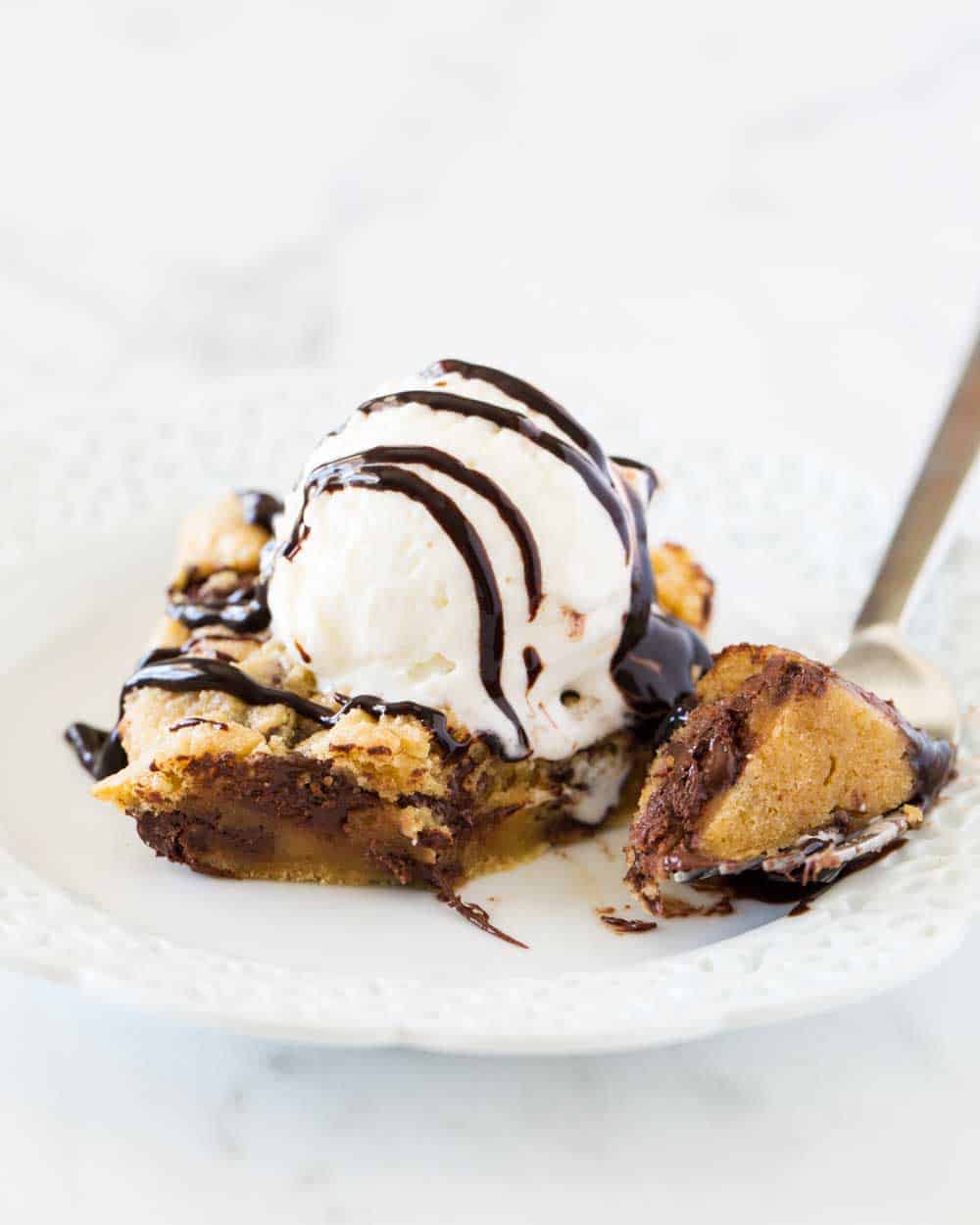 Chocolate chip cookie bars on a white plate. 