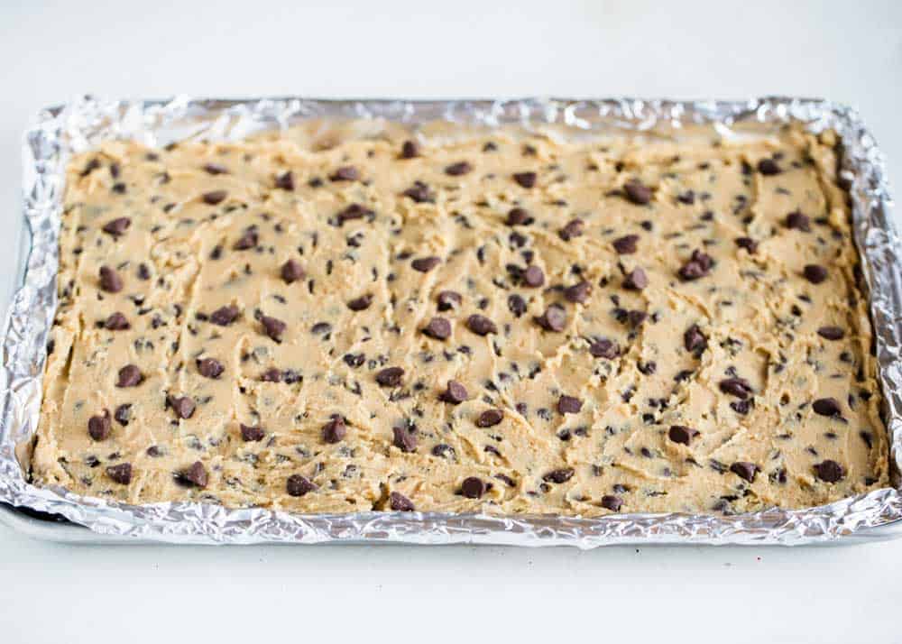 These congo bars are a soft and chewy chocolate chip cookie bars made using one bowl and a sheet pan. They are so easy to make and are perfect for a crowd! Cookie bars on a baking sheet.