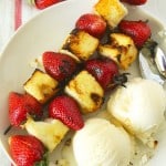 grilled strawberry shortcake skewers on a plate with ice cream