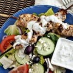 grilled chicken tzatziki salad on blue plate