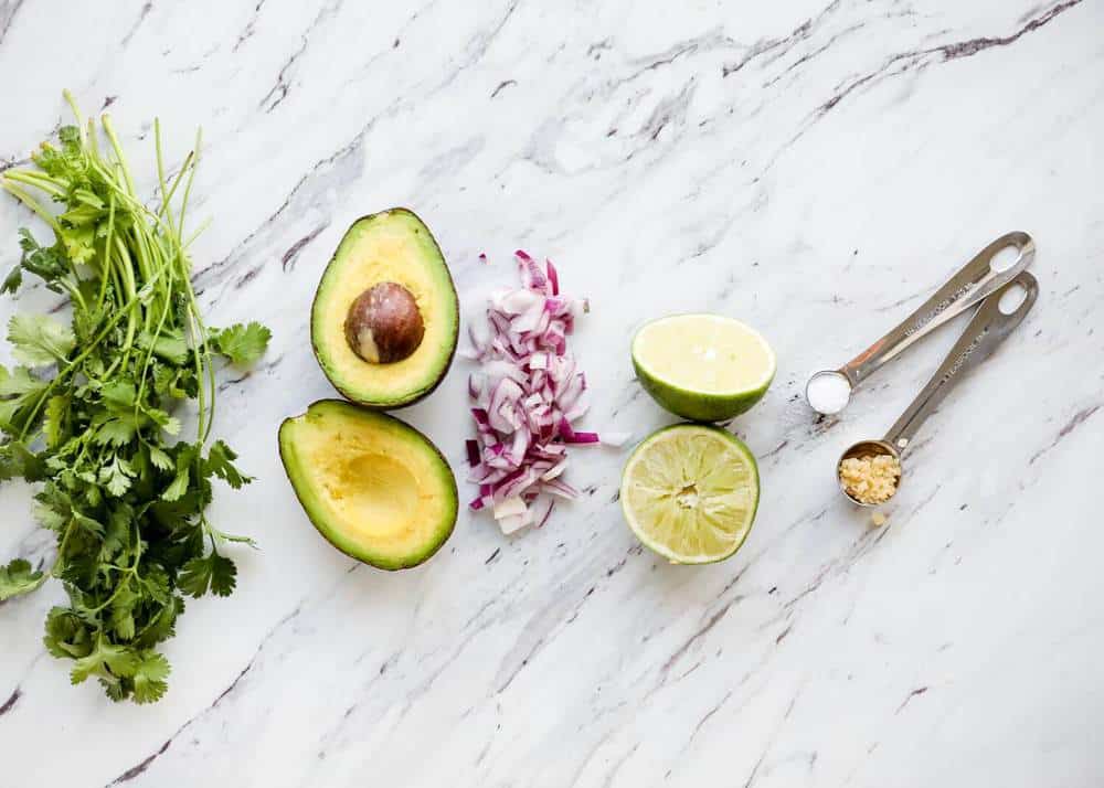 Guacamole ingredients on counter.