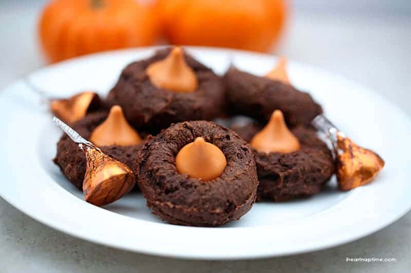plate of pumpkin chocolate cookies with a pumpkin Hershey's kiss on top