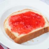 piece of homemade bread topped with fresh strawberry jam