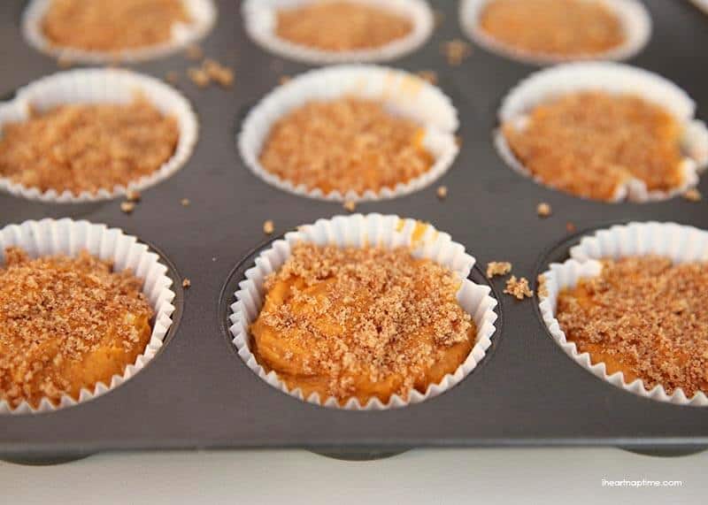 cupcake liners filled with pumpkin muffin batter 