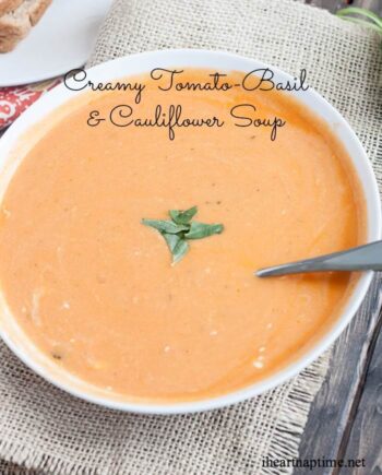 A bowl of tomato basil cauliflower soup with a spoon