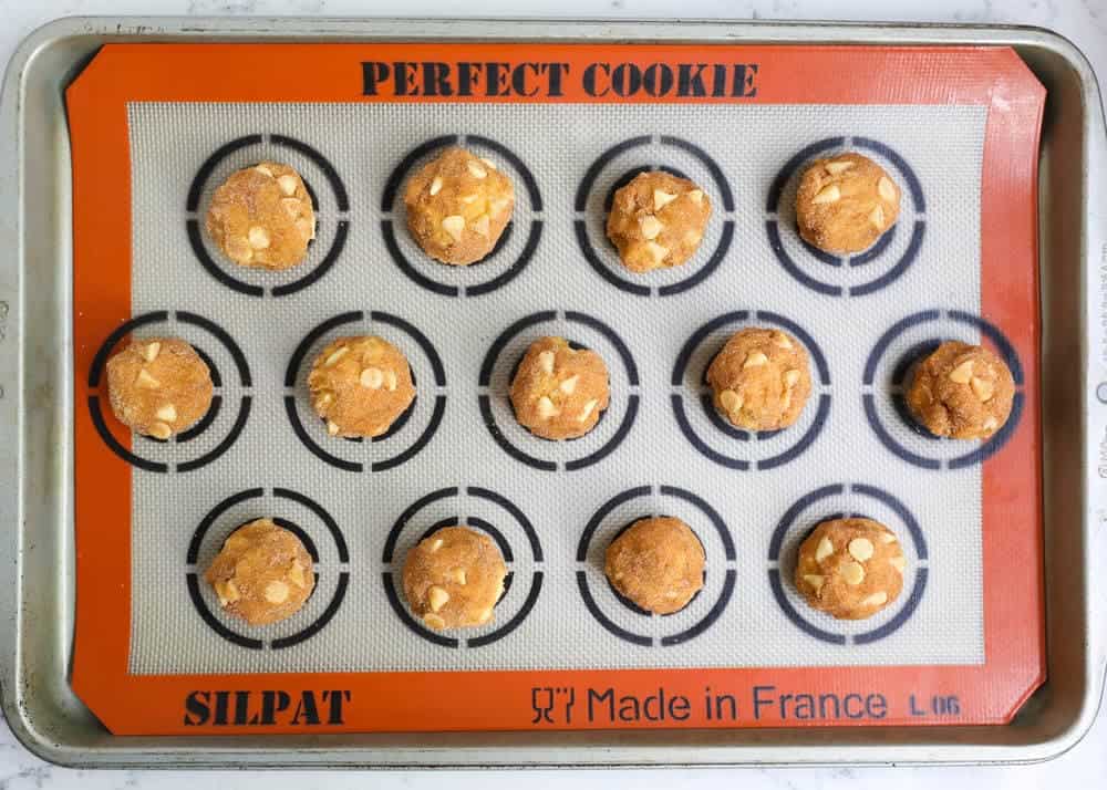 pumpkin white chocolate chip cookie dough balls on a silpat cookie mat 