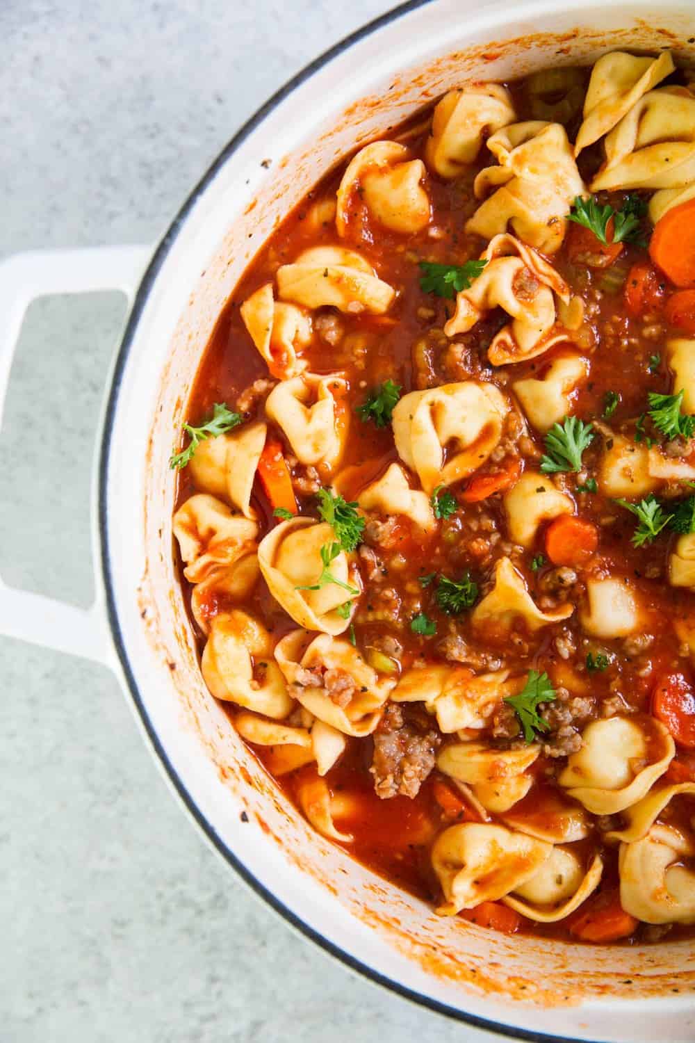 Sausage tortellini soup in pot.