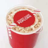 candy cane popcorn in a red bucket with a label