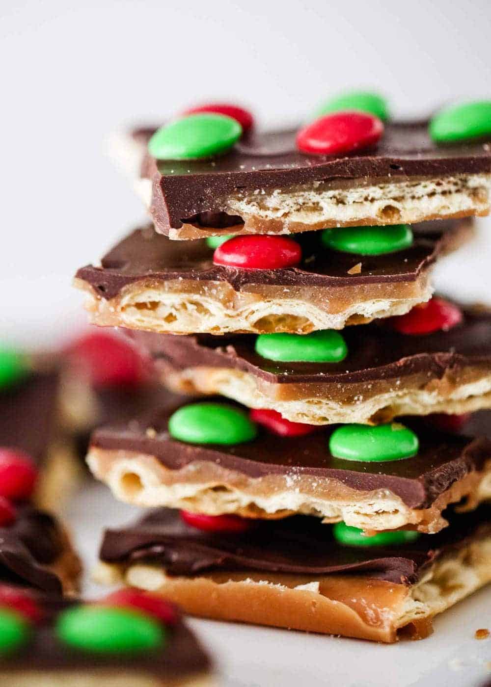 A close up of a stack of Christmas crack toffee.