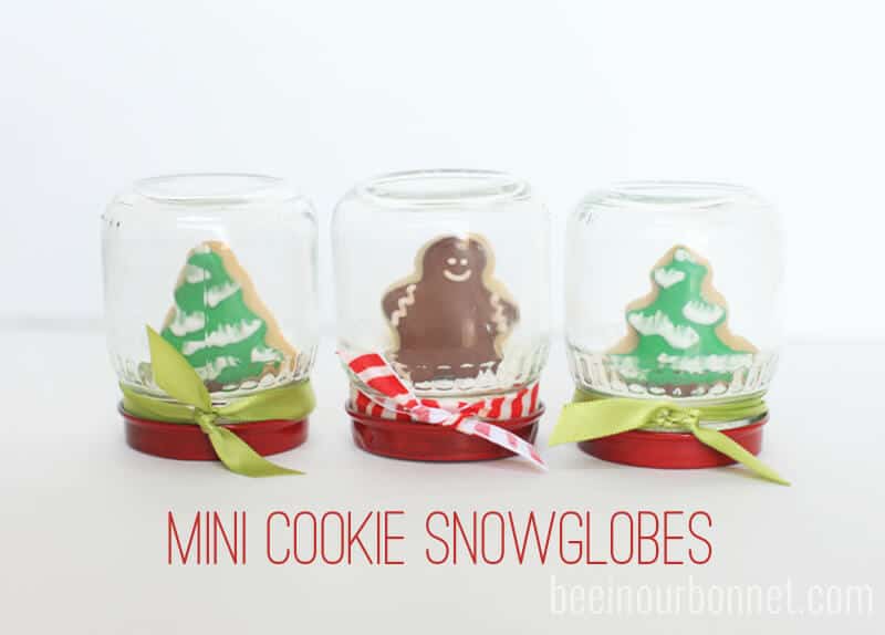 mini cookie snow globes sitting on counter 