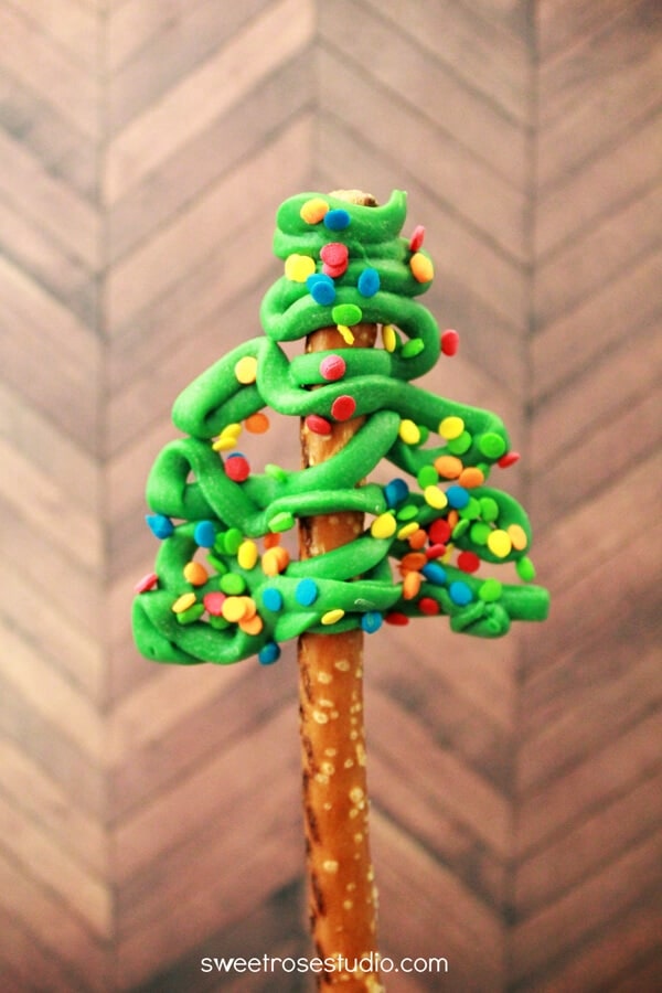 A close up of a christmas tree pretzel rod 