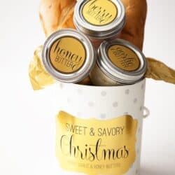 compound butter jars in a christmas box with french bread