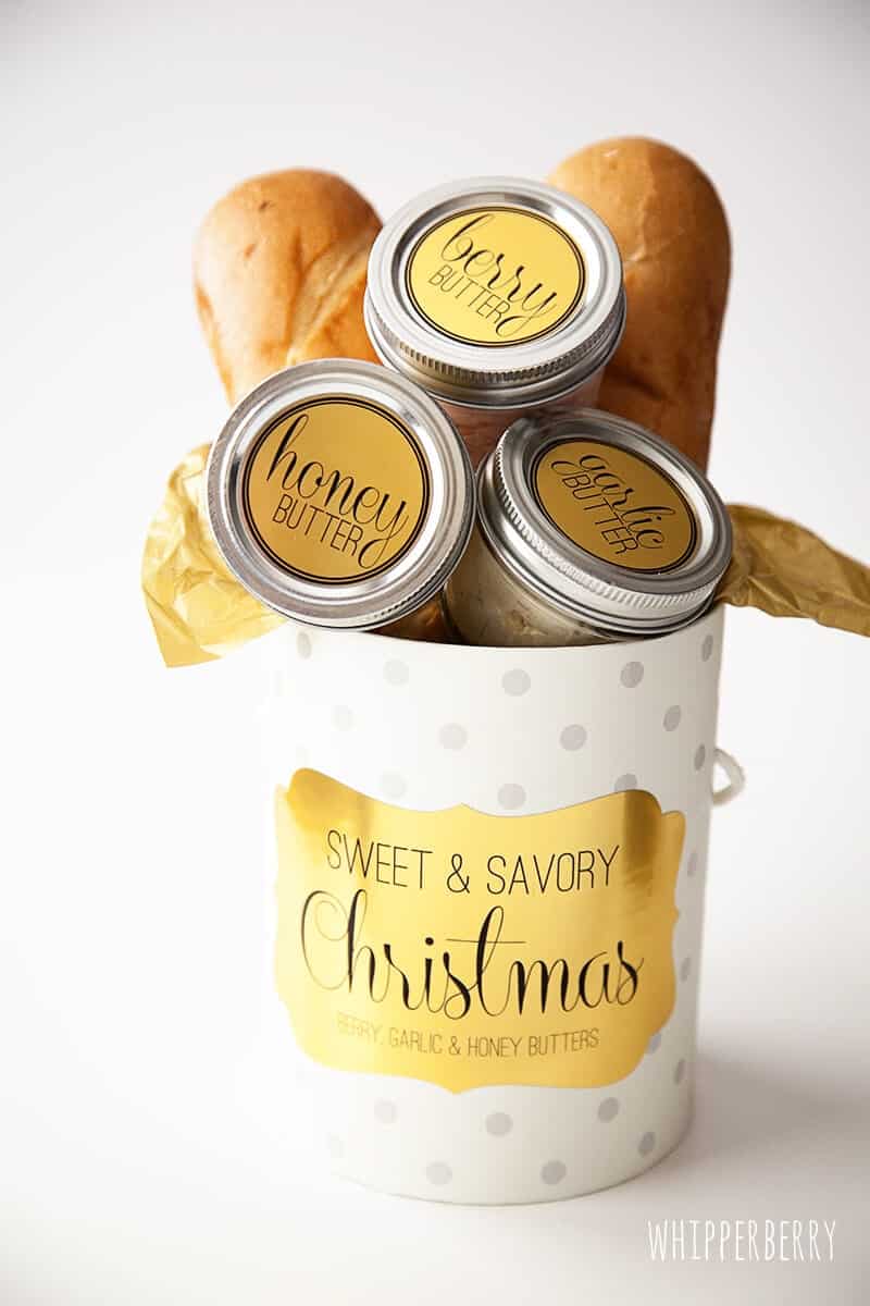 Compound butter jars in a Christmas box with french bread.