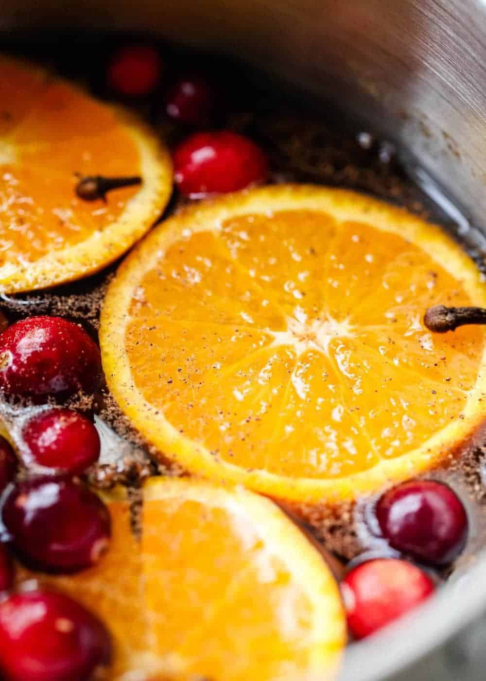 A close up of stovetop potpourri with fresh orange slices and cranberries.