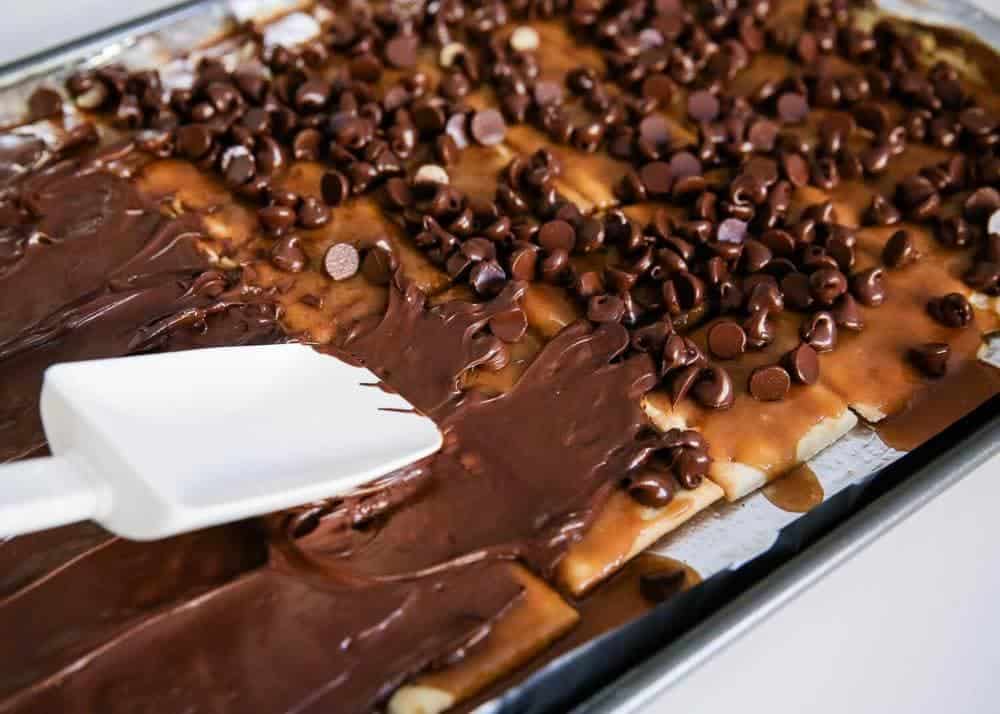 Spread chocolate on top of saltine toffee.