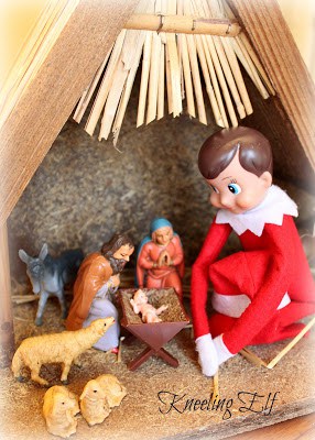 Elf sitting in the nativity