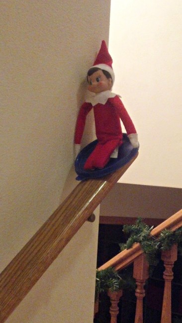 Elf sliding down the railing.