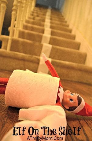 Elf rolling down the stairs in toilet paper