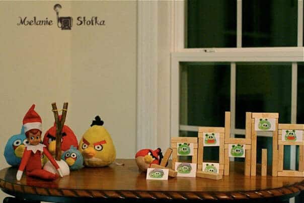 Top 50 of the BEST Elf on the Shelf ideas - So many fun ideas to do with your Elf leading up to Christmas! Your family will love these list amazing list of elf ideas! Elf playing with angry birds