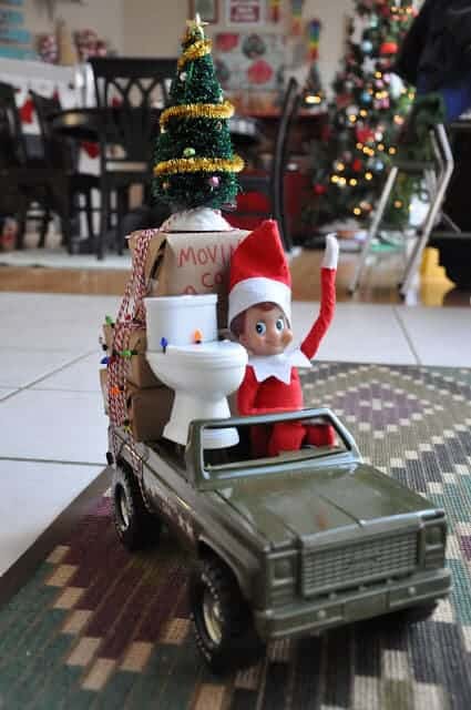 Elf in a toy truck.