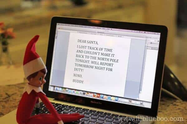 Elf writing a letter to Santa on the computer.