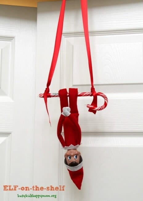 Elf swinging from a candy cane.