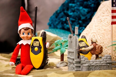 Elf holding a walkie talkie.
