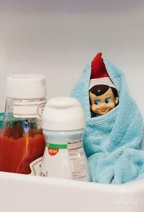 Elf in a dish towel in the fridge