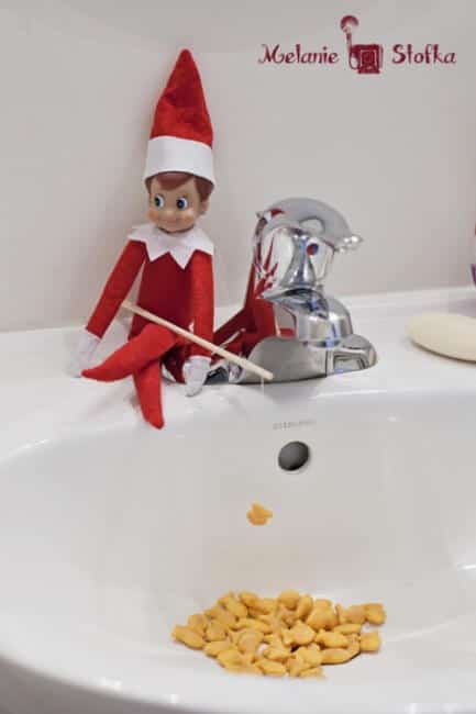 Top 50 of the BEST Elf on the Shelf ideas - So many fun ideas to do with your Elf leading up to Christmas! Your family will love these list amazing list of elf ideas! Elf fishing with gold fish
