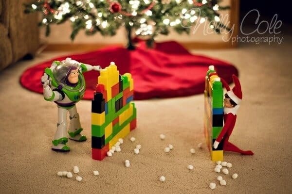 Elf doing a snowball fight with marshmallows.