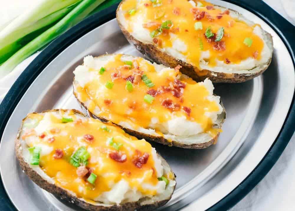 twice baked potatoes on a silver plate 