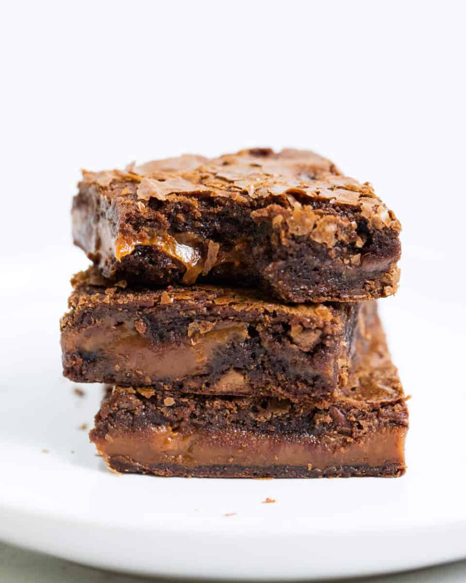 Easy to make chocolate caramel brownies that are loaded with chocolate chips and layers of gooey caramel. Rich, chewy and simply amazing! stack of chocolate caramel brownies