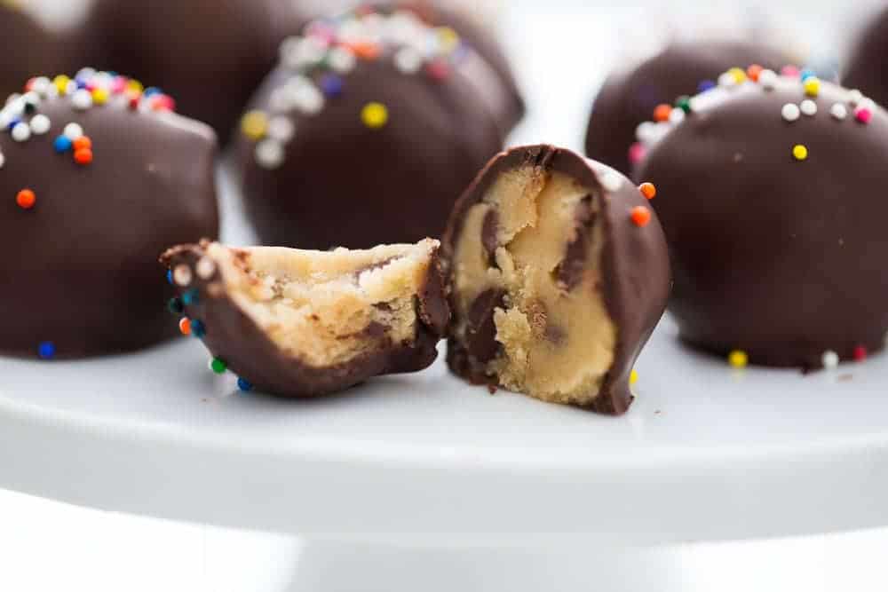 Chocolate chip cookie dough truffles on a cake stand.