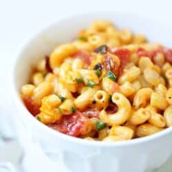 bacon and chive macaroni and cheese in a white bowl