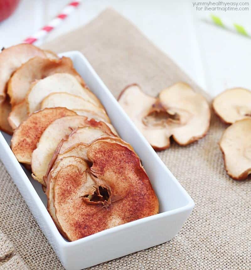 baked cinnamon apple chips in a white bowl 