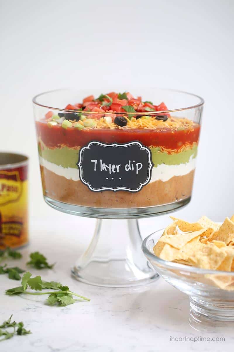 The BEST 7 layer dip recipe -layers of salsa, guacamole, sour cream, beans, cheese, pico de gallo and olives.
