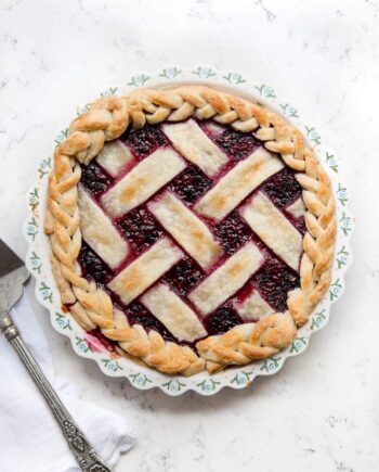 razzleberry pie with lattice crust in a pie dish