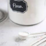 flour jar on counter with measuring spoons