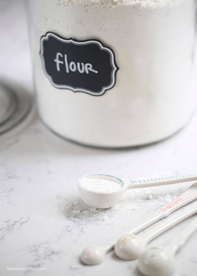 flour jar on counter with measuring spoons